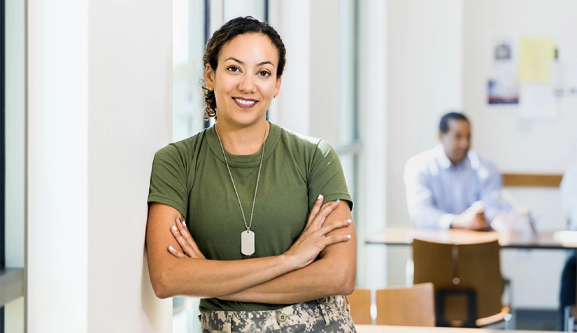 Person dressed in casual military outfit smiling for camera