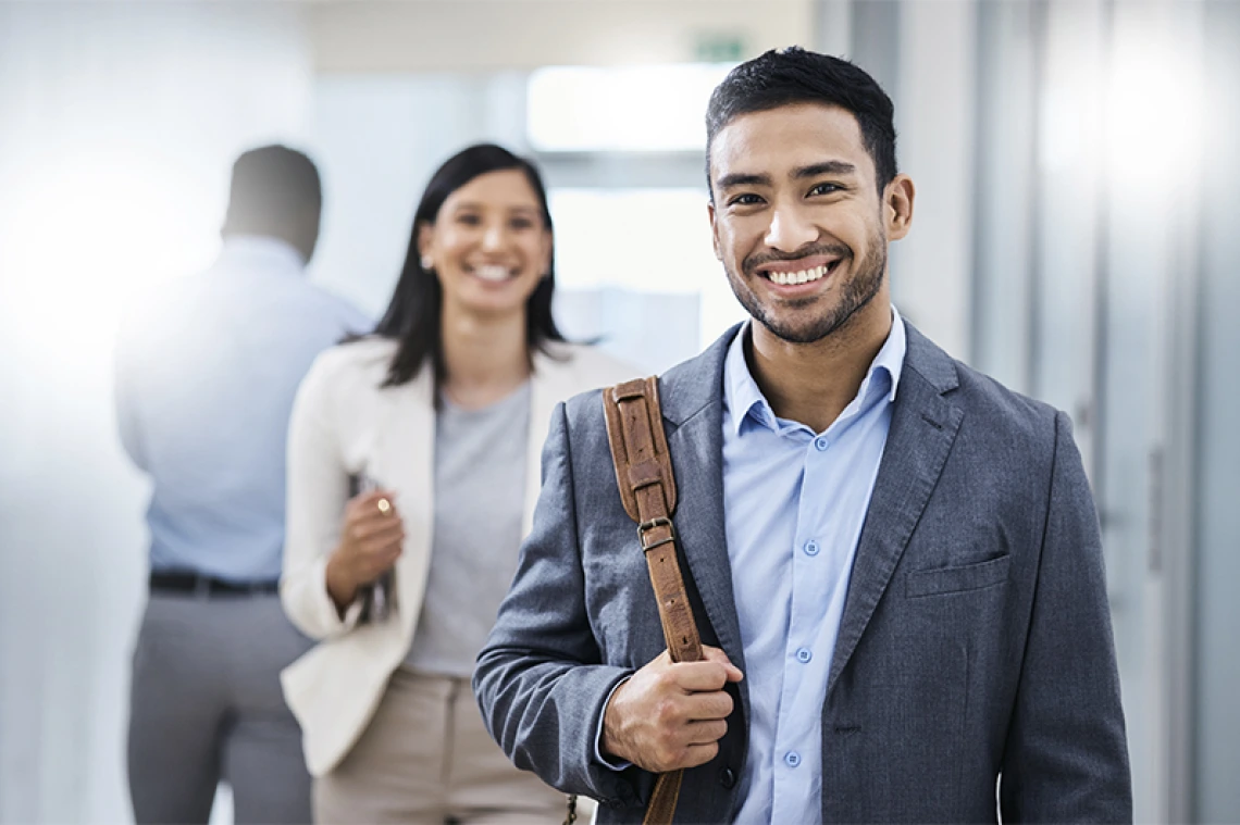 Smiling business person walking in hallway