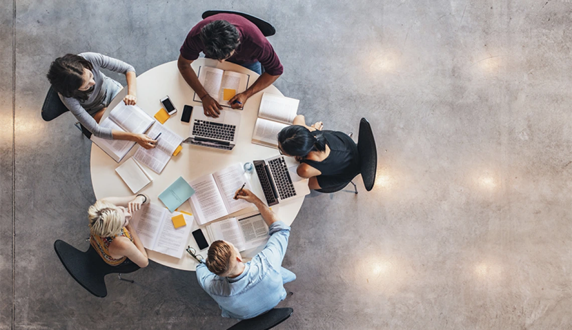Aerial shot of a group of people working together at a table