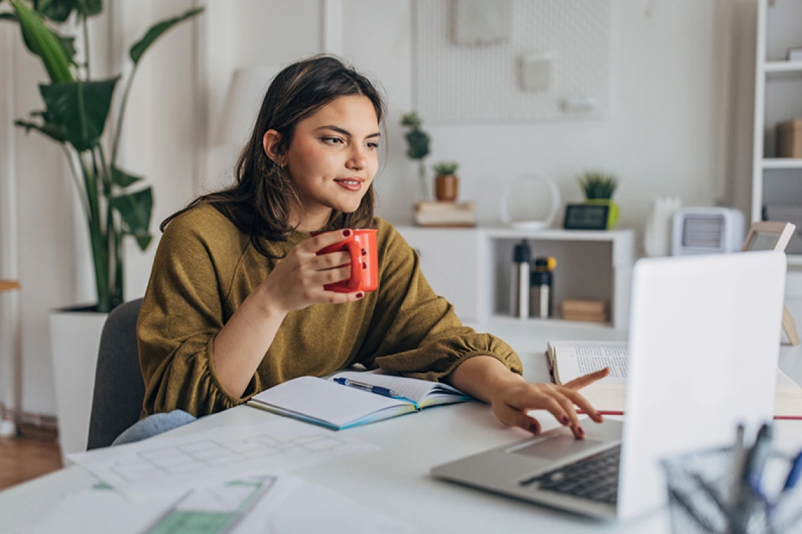 Student working on laptop in home setting