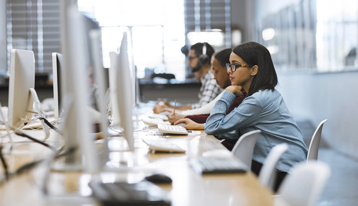 Student sitting at computer in computer lab setting